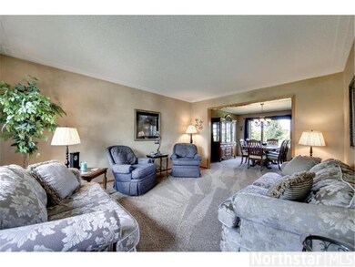 Formal living room boasts bay windows and race tra