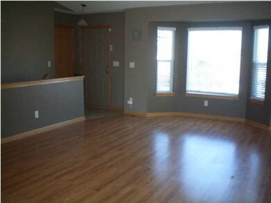 Gleaming wood laminate floors greet you as you ent