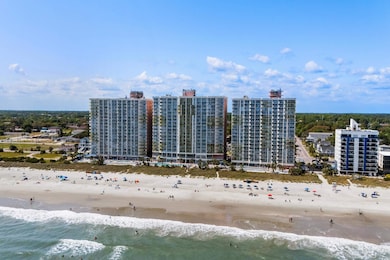 Birds eye view of property with a water view and a