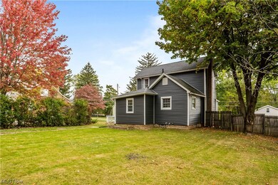 Back of house featuring a lawn