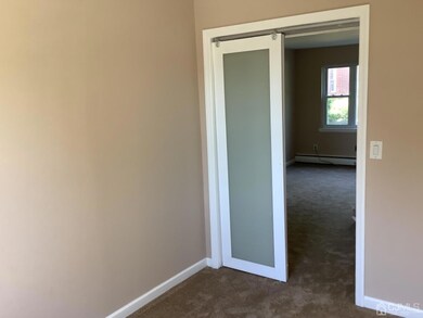 Room off the living room, 2nd door to the back.