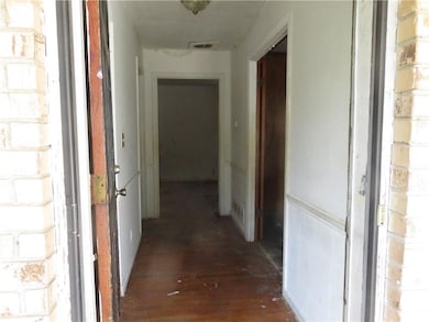 Corridor with hardwood / wood-style flooring