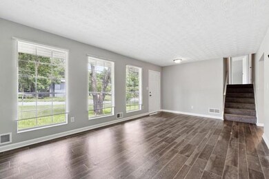 Unfurnished room featuring dark wood finished floo