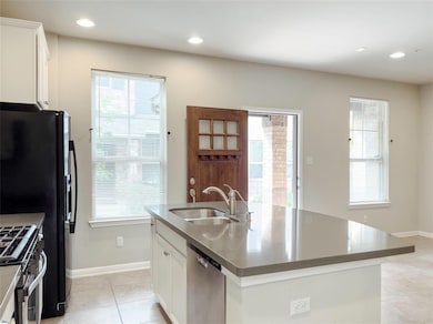 Kitchen featuring stainless steel appliances, lig