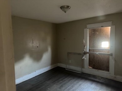 Spare room with dark wood-type flooring