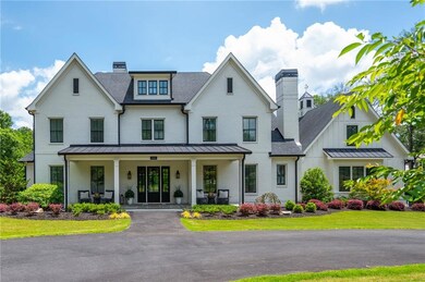 Timeless luxury farmhouse style home greets you with welcoming curb appeal and circular driveway