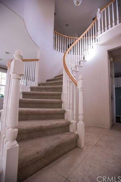 Elegant entry with beautiful spiral staircase.