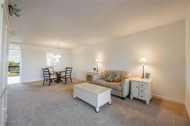 Living room with light colored carpet and a textur