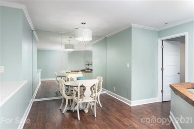 DINING AREA UPDATED WITH NEW LIGHT FIXTURE, UPDATED FLOORING, CUSTOM CRAFTED WOOD TO TOP OFF DIVIDER WALL, UPDATED PAINTING.