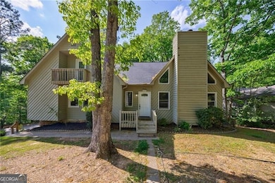 View of front of house featuring a shingled roof, 