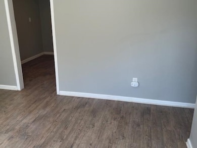Unfurnished room with dark hardwood / wood-style f