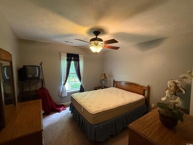 Bedroom featuring carpet flooring and ceiling fan