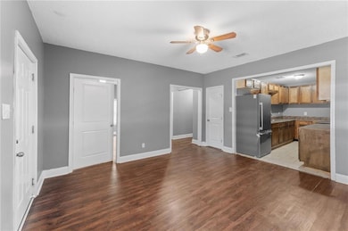 Unfurnished living room featuring light wood-type flooring and a ceiling fan