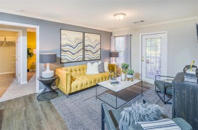 Living room featuring crown molding and carpet floors