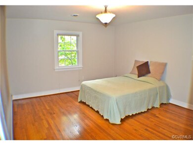 spacious master bedroom with beautiful wood floors