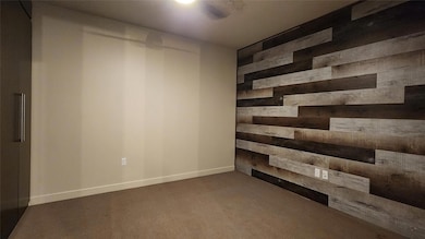 Carpeted empty room with wooden walls