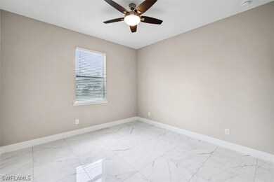Tiled spare room with ceiling fan