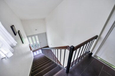 Staircase featuring a high ceiling