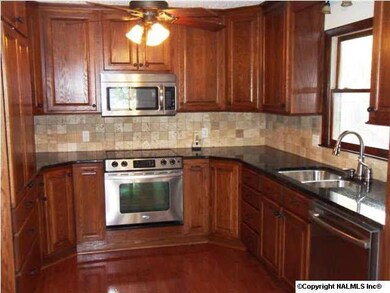 Kitchen with hardwoods, backsplash and stainless appliances