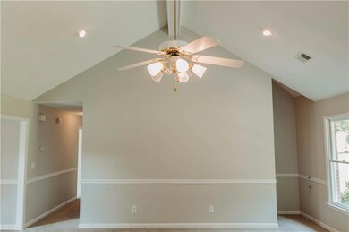 Spare room featuring ceiling fan and baseboards