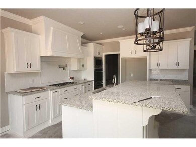 Kitchen. Huge kitchen island, double ovens, granite countertops, walk in pantry and large breakfast area