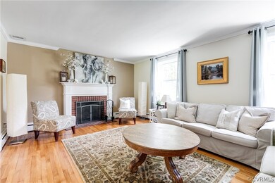 The living room has hardwood flooring, crown molding, and wood-burning fireplace.