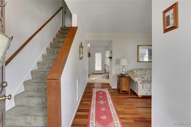 Entrance foyer with wood finished floors and stairway