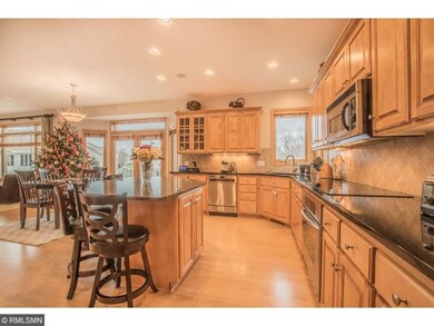 Kitchen with large center island, tile backsplash,