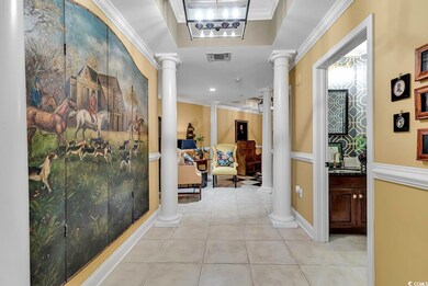 Hall featuring sink, crown molding, ornate columns