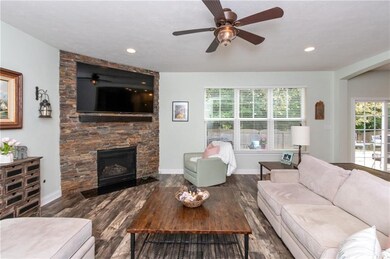 Drystack stone gas fireplace with flatscreen TV wiring above makes this family room cozy & inviting.