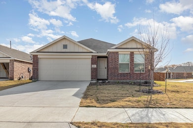 Single story home with brick siding, an attached g