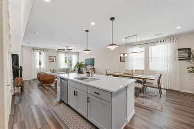 Kitchen with sink, dishwasher, a center island with sink, and dark hardwood / wood-style flooring