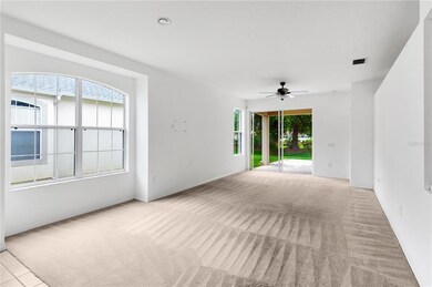 Looking from Tile Foyer area through Living Room to the Covered Patio Out Back