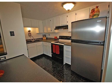 Kitchen. Newer appliances and painted cabinets wit