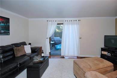 Sliding glass door in neutral Living Room leads to