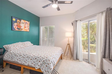 Bedroom with ceiling fan, access to outside, and 