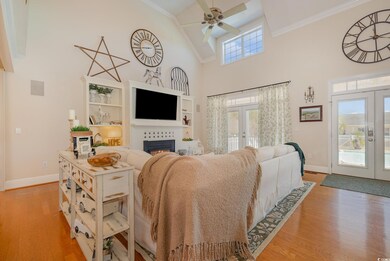 Living room with french doors, light hardwood / wo