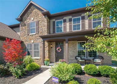 Covered front porch with lovely landscaping.