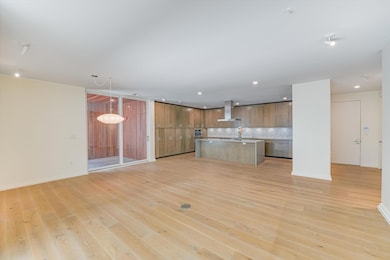 Kitchen featuring wall chimney exhaust hood, ligh