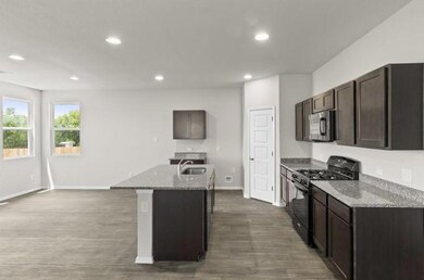 Kitchen with gas stove, stainless steel microwave