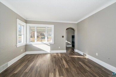 Unfurnished room with dark wood-type flooring