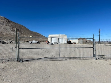 View of dirt / gravel road featuring a gated entry