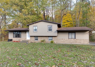 View of front of home featuring a front yard and brick siding