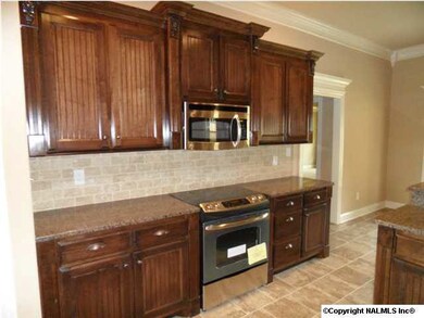Kitchen has custom cabinets, stainless appliances, granite counter tops, tile floors, recessed lighting, tile back splash and pantry.