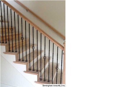Scissor staircase with iron railing is located to 