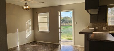 DINING AREA WITH BACK YARD IN DISTANCE