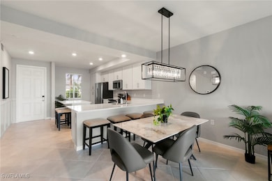 Dining space with recessed lighting and light tile patterned floors