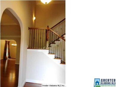 Impressive entry with an arched opening and iron r