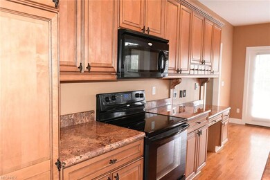 The gourmet kitchen boasts upgraded materials with