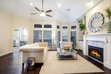 Living room featuring ceiling fan, a fireplace, da